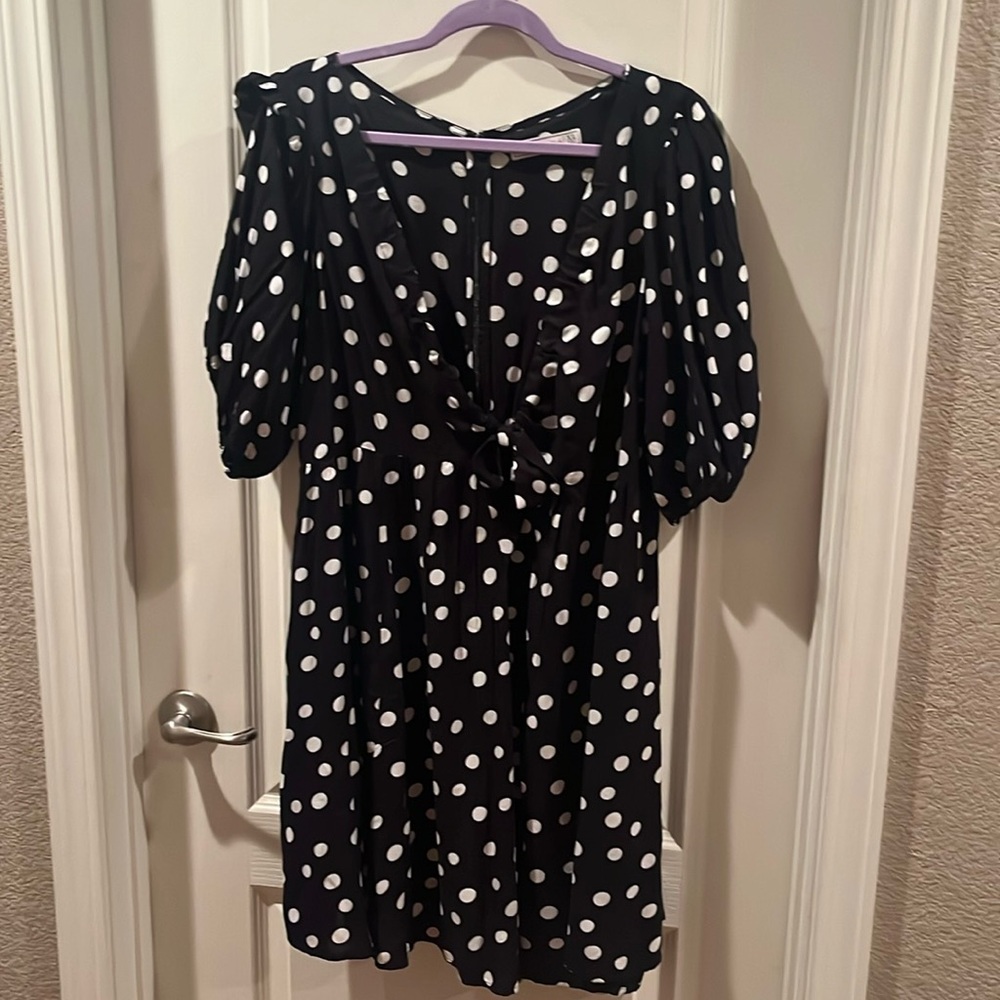 Women’s black dress with deep V neck and bow accent
